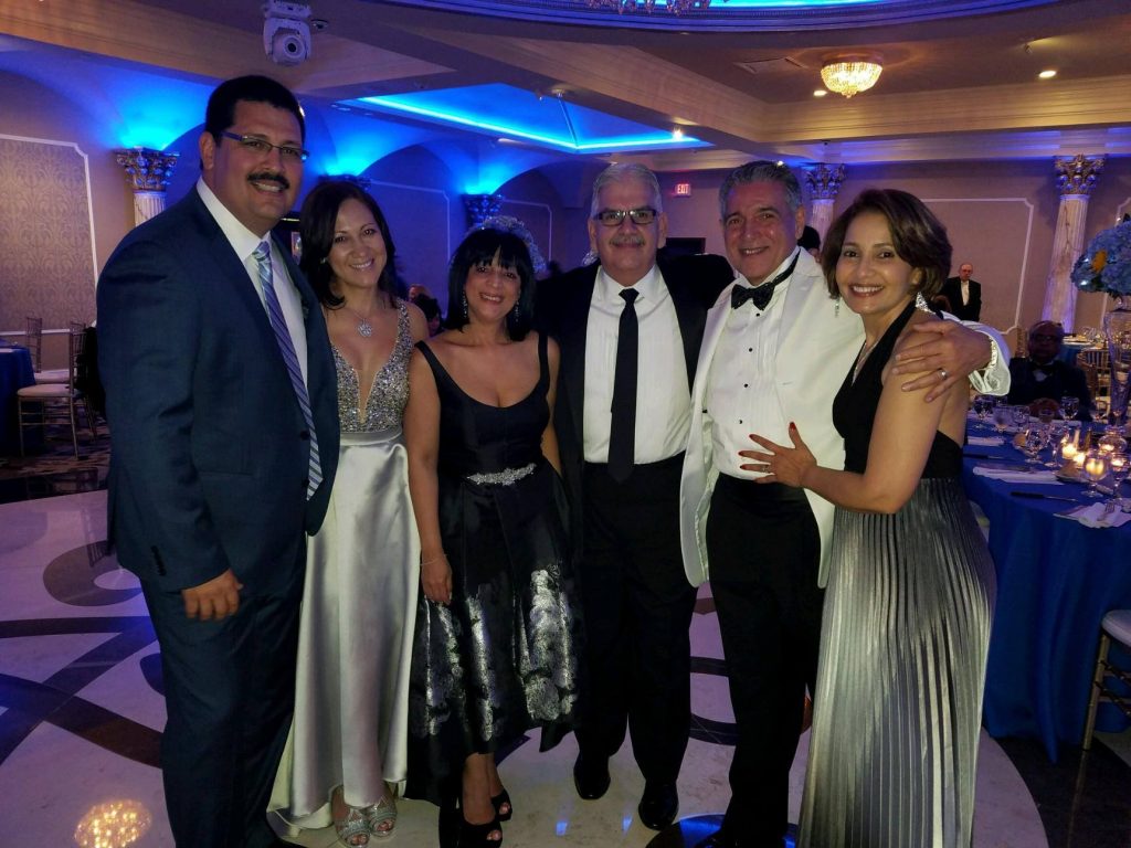 Dr. Gregorio Guillen, (in white tuxedo), together with Alameda QAPI Director Dr. Romel Arjona, (left) and Spanish Program Director Dr. Jorge Gonzalez Gomez (center). All joined by their lovely wives Miriam, Rosario and Adaligia (L to R).